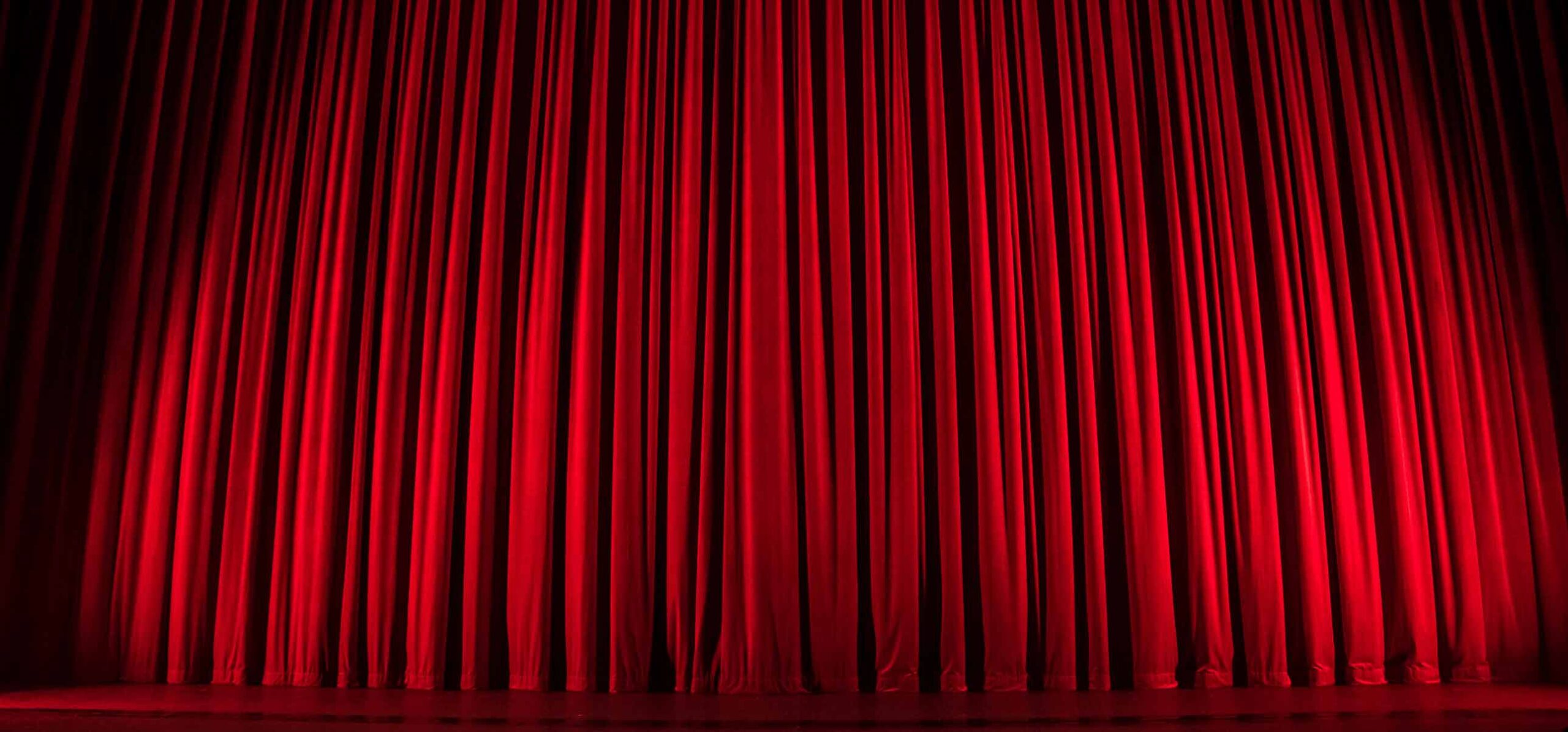 Red curtain across a stage.