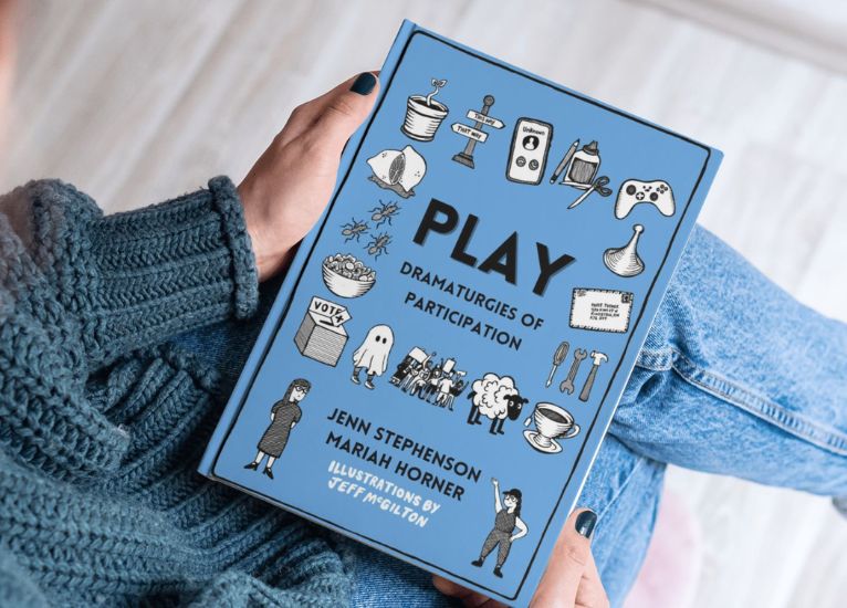 Image of someone holding the book 'PLAY: Dramaturgies of Participation'.