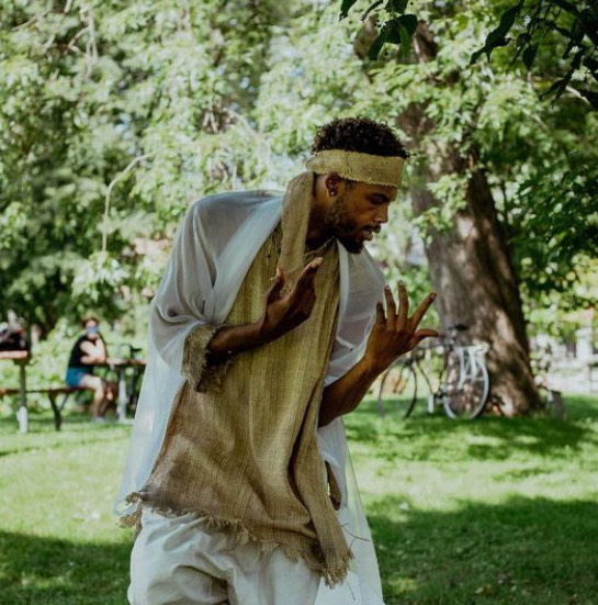 A man dancing in a park.