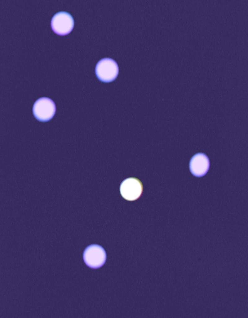 A purple background with six glowing dots dispersed in the image. One glowing dot is especially brighter than the other five. 