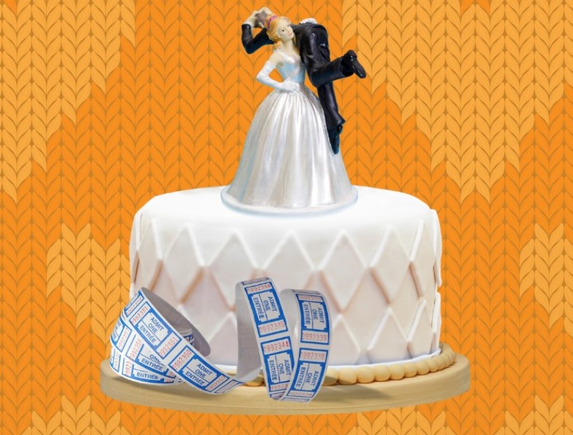 a wedding cake with bride and groom toppers