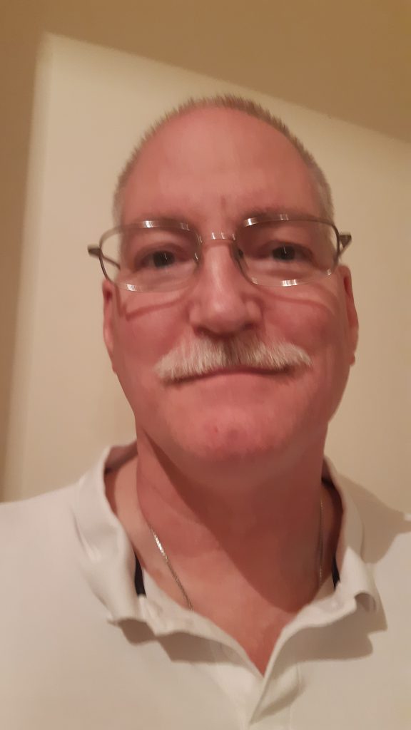headshot of a man smiling