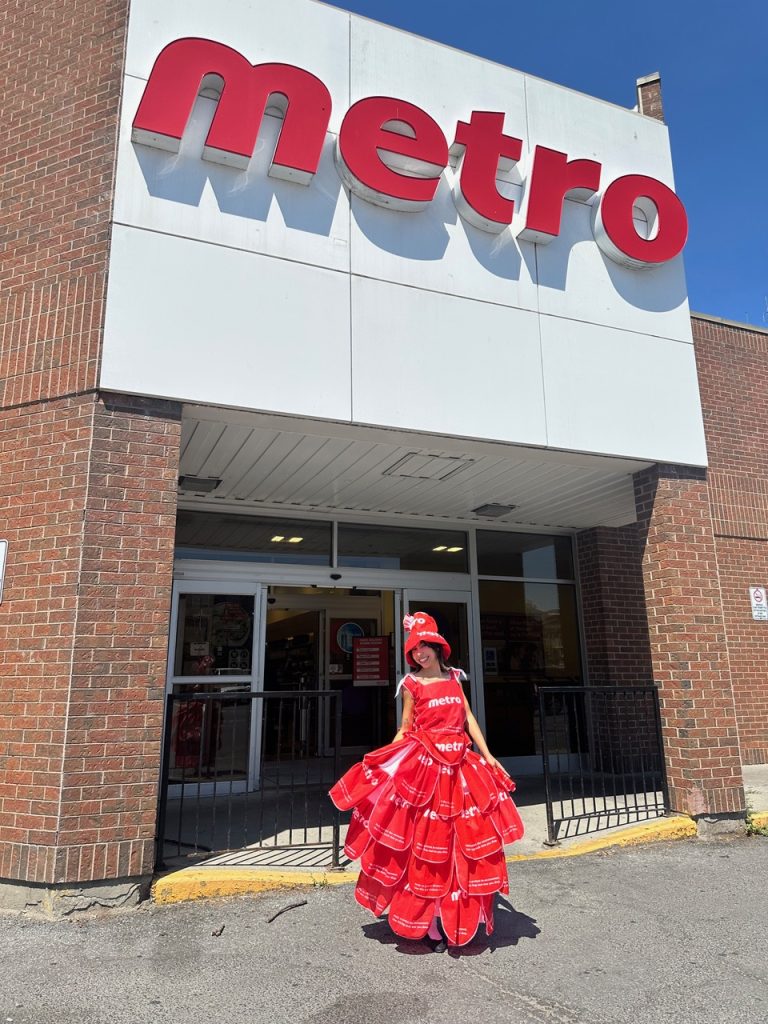 Woman wearing a dress made out of reusable Metro bags.
