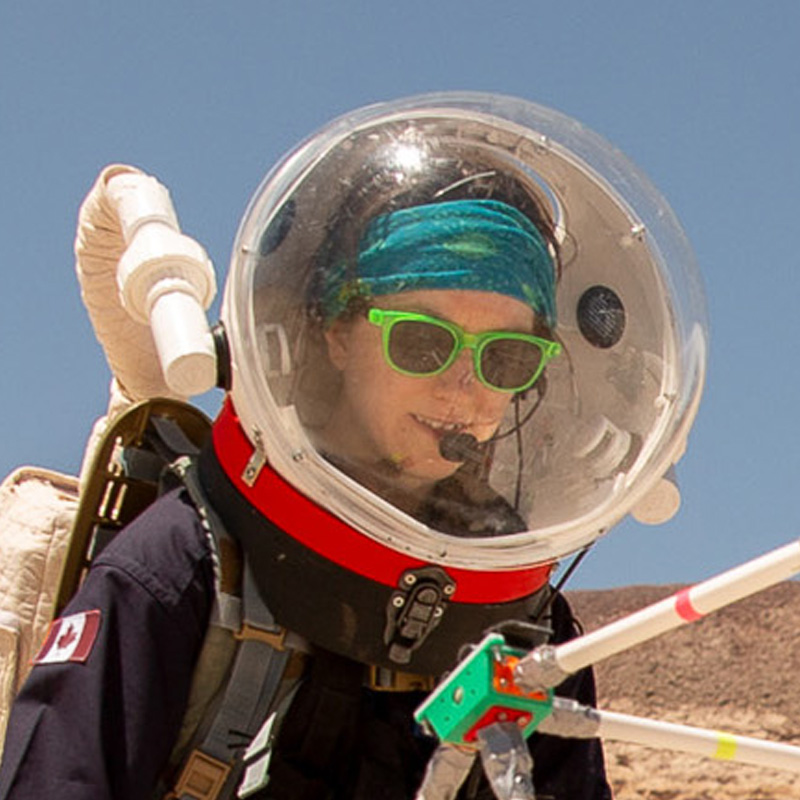 Erin Kennedy wearing a space suit and helmet